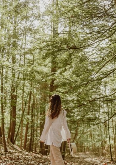 Lady walking in the forest enjoying a moment to herself to relax